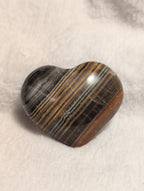 Bumblebee Calcite heart-shaped crystal from Syn's Crystal Co, showcasing yellow and black striped mineral with smooth polished surface.