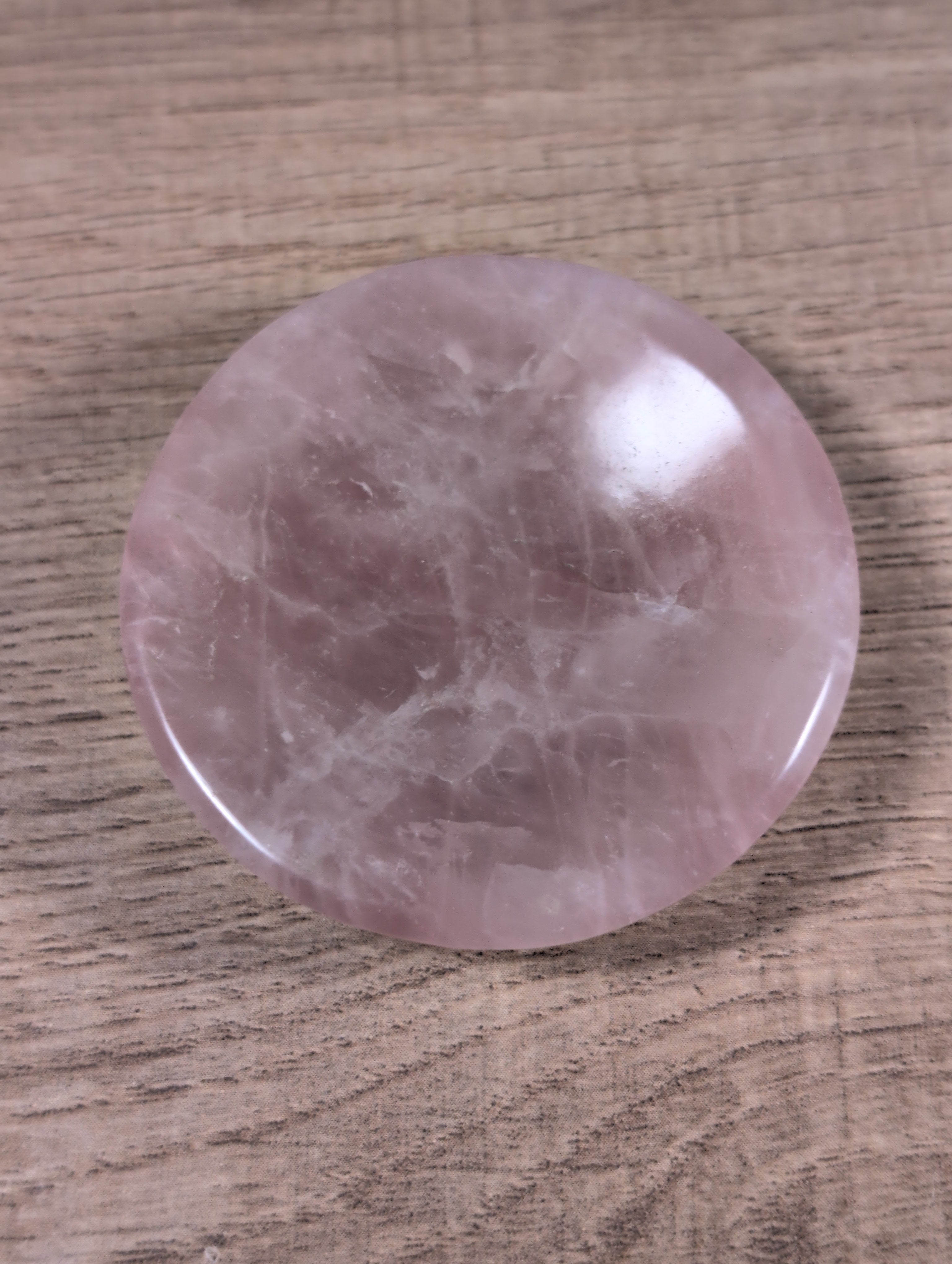 Round rose quartz bowl from Syn's Crystal Co, featuring smooth pink stone with natural veining and polished finish.