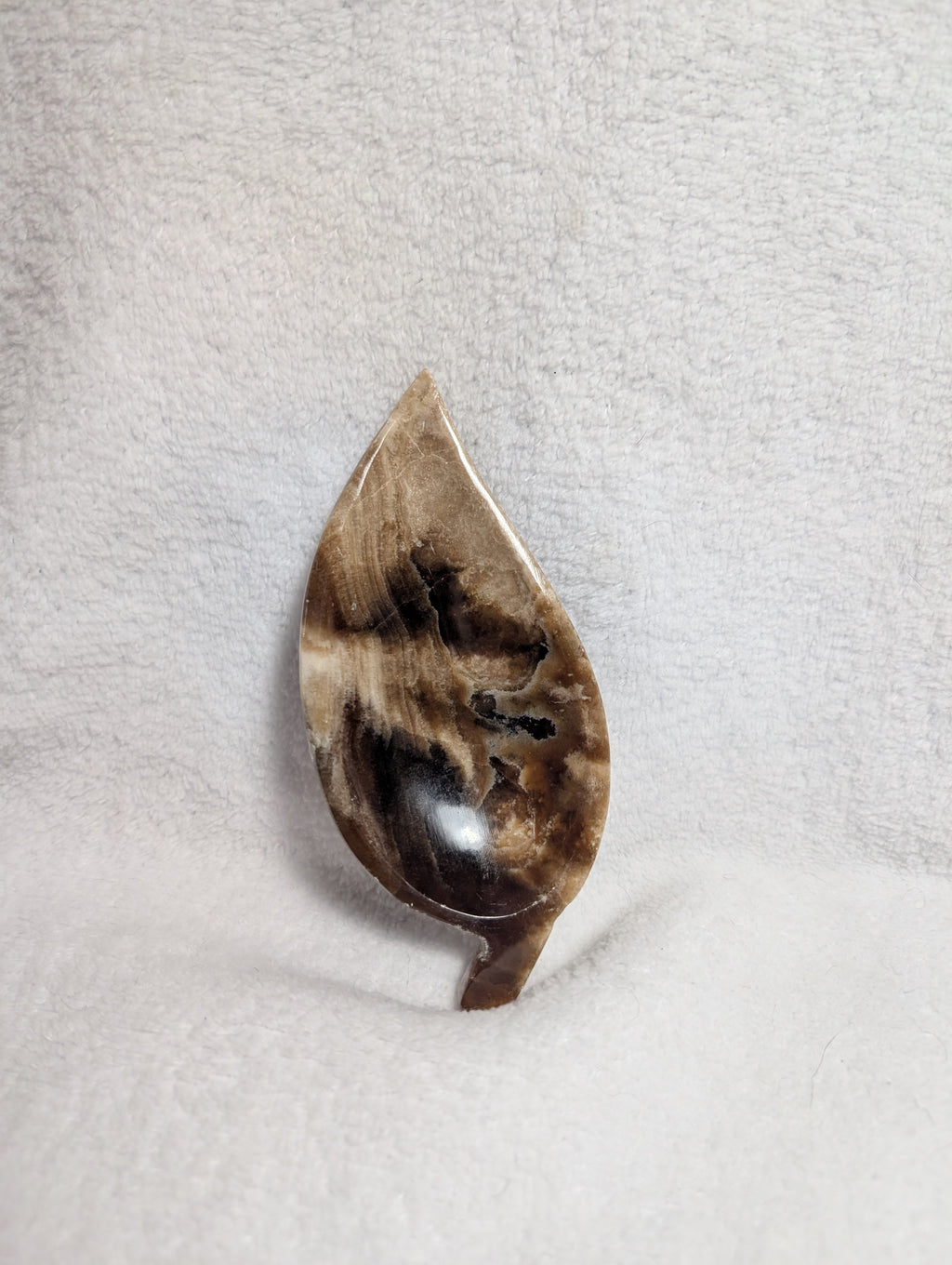 Chocolate Calcite Leaf carving by Syn's Crystal Co, featuring detailed leaf shape and rich brown tones in a polished stone.
