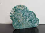 Green Aventurine sun and cloud carving by Syn's Crystal Co, featuring detailed green stone shapes of the sun and clouds.