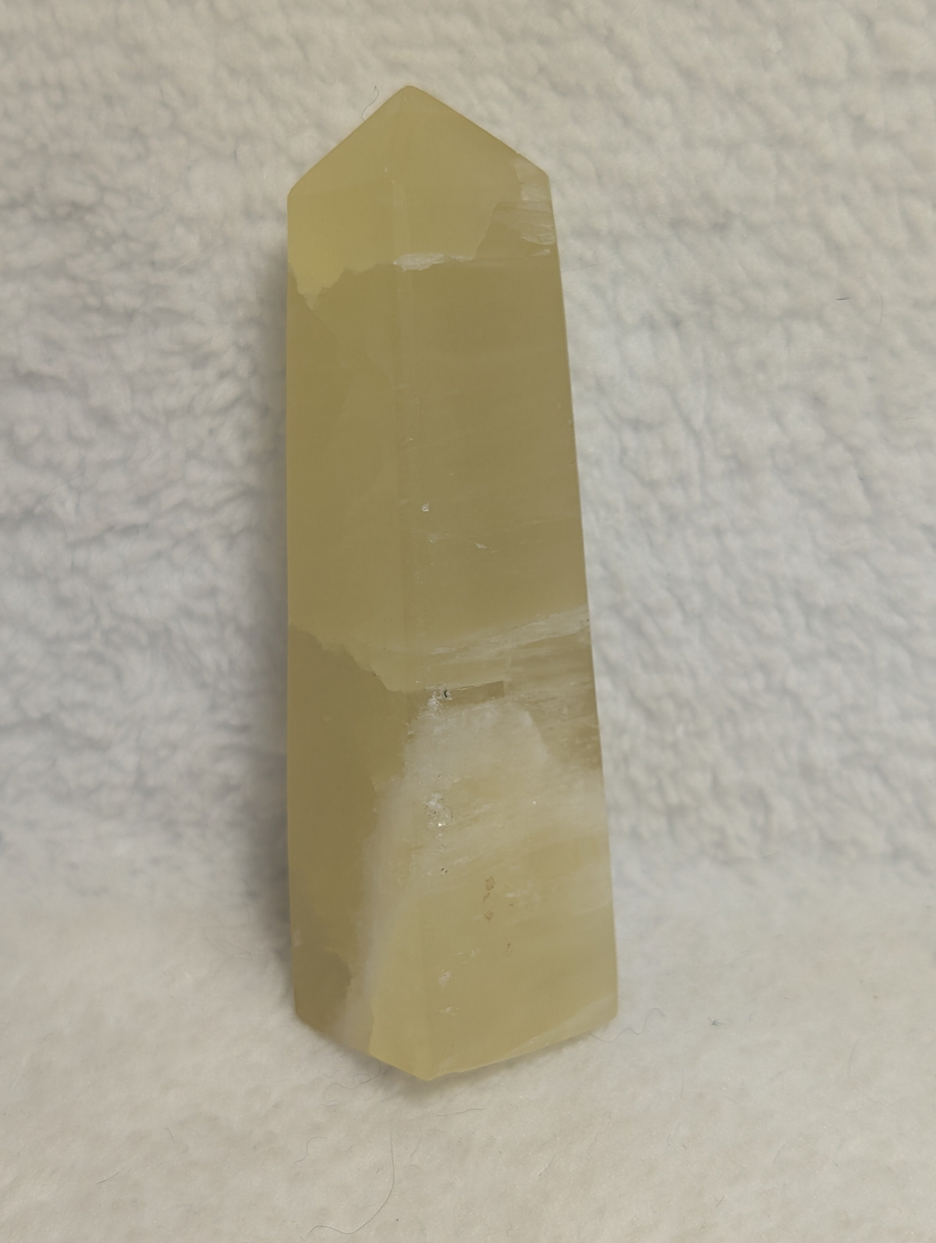 Lemon Calcite Tower from Syn's Crystal Co, showing a vibrant yellow mineral crystal with natural texture and polished facets.