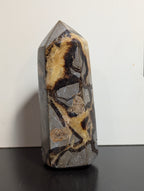 Septarian tower crystal from Syn's Crystal Co with earthy yellow and brown natural mineral patterns.