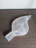 Carving of a silky white calcite leaf by Syn's Crystal Co, featuring detailed natural crystal textures and smooth polished surfaces.