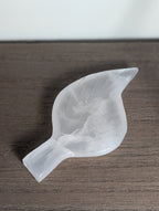 Carving of a silky white calcite leaf by Syn's Crystal Co, featuring detailed natural crystal textures and smooth polished surfaces.