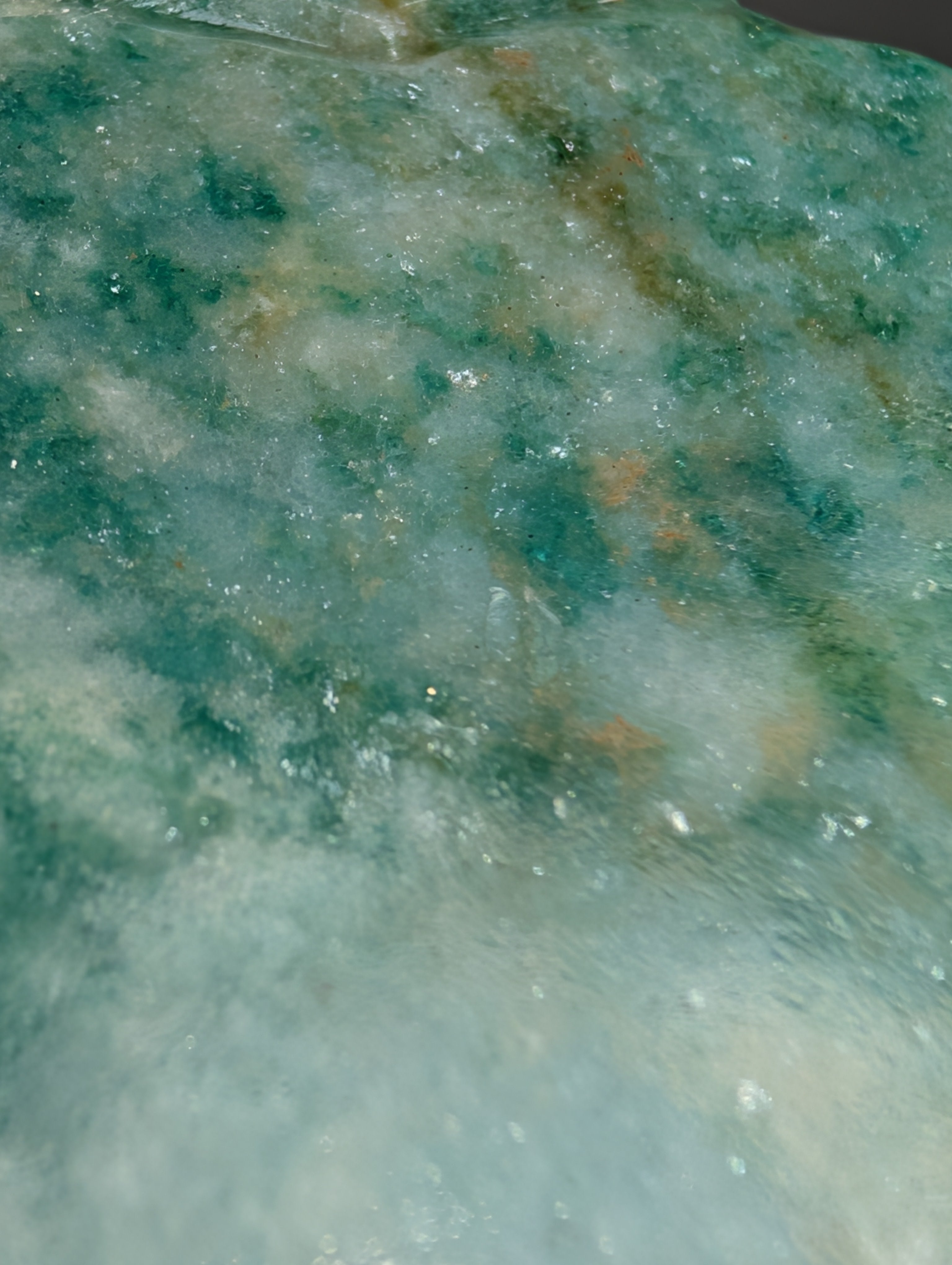 Green aventurine sun and cloud carving by Syn's Crystal Co, featuring a detailed crystal sculpture with sun and cloud motifs.
