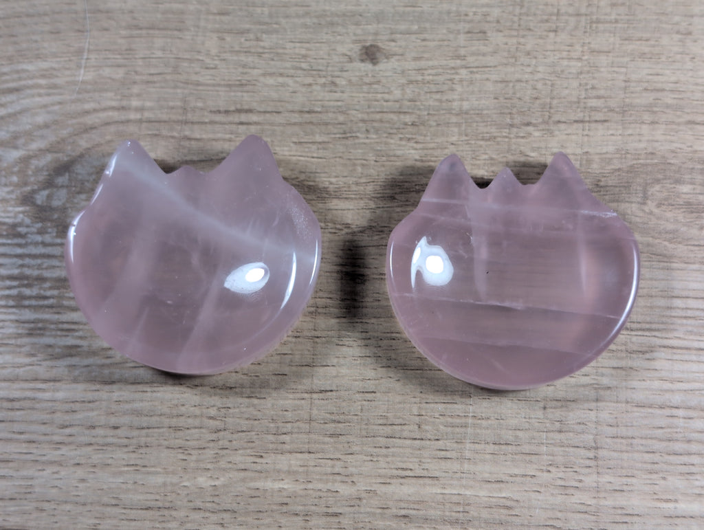 Pink rose quartz cat-shaped bowl with smooth, polished surface, showcasing the crystal's natural translucence and gentle curves.
