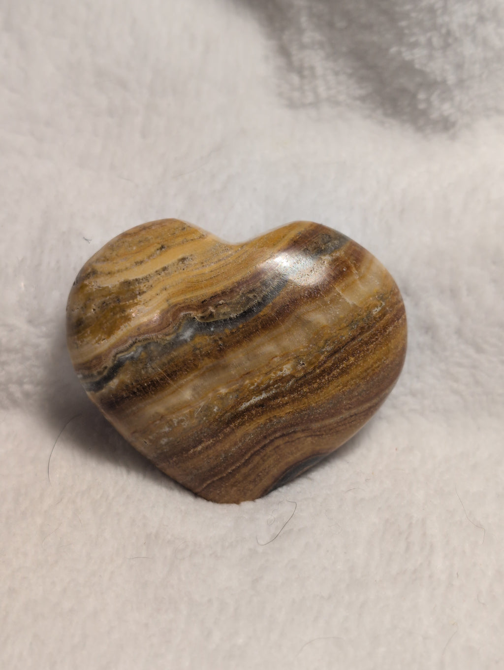 Smooth Bumblebee Calcite heart-shaped crystal from Syn's Crystal Co with vibrant yellow and black banding on a white background.