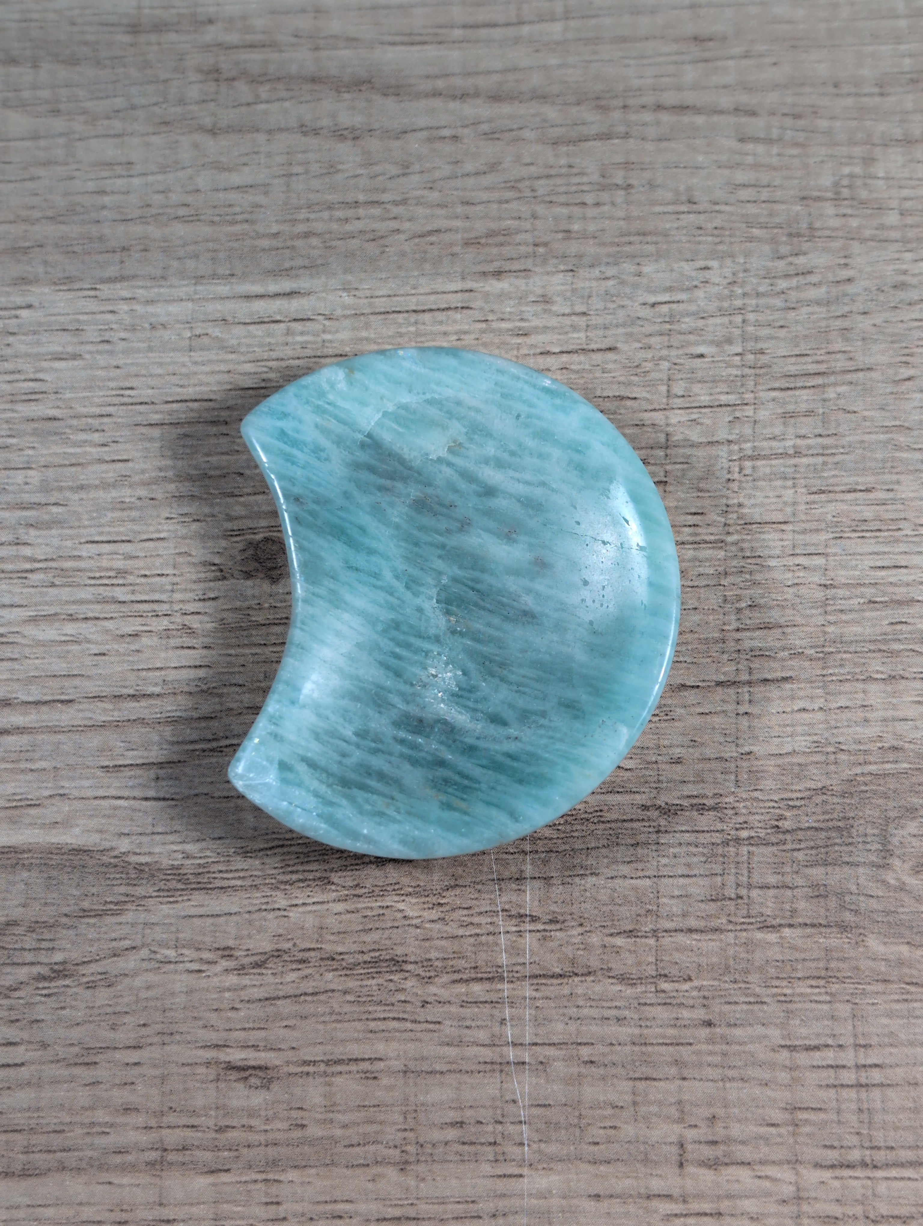Half-moon shaped Amazonite bowl with natural blue-green patterns, crafted by Syn's Crystal Co.