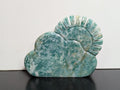 Green Aventurine sun and cloud carving by Syn's Crystal Co featuring detailed sun and cloud shapes on a polished green aventurine stone.