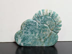 Green Aventurine sun and cloud carving by Syn's Crystal Co featuring detailed sun and cloud shapes on a polished green aventurine stone.