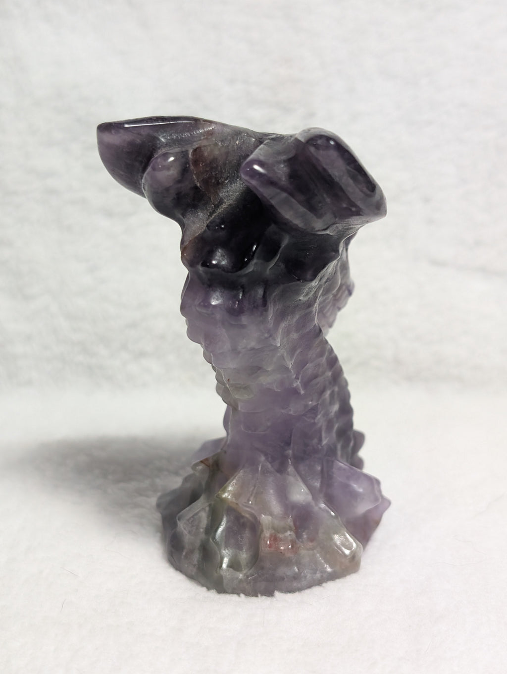 Detailed dragon head carving from Syn's Crystal Co, showcasing intricate craftsmanship and textured surface.