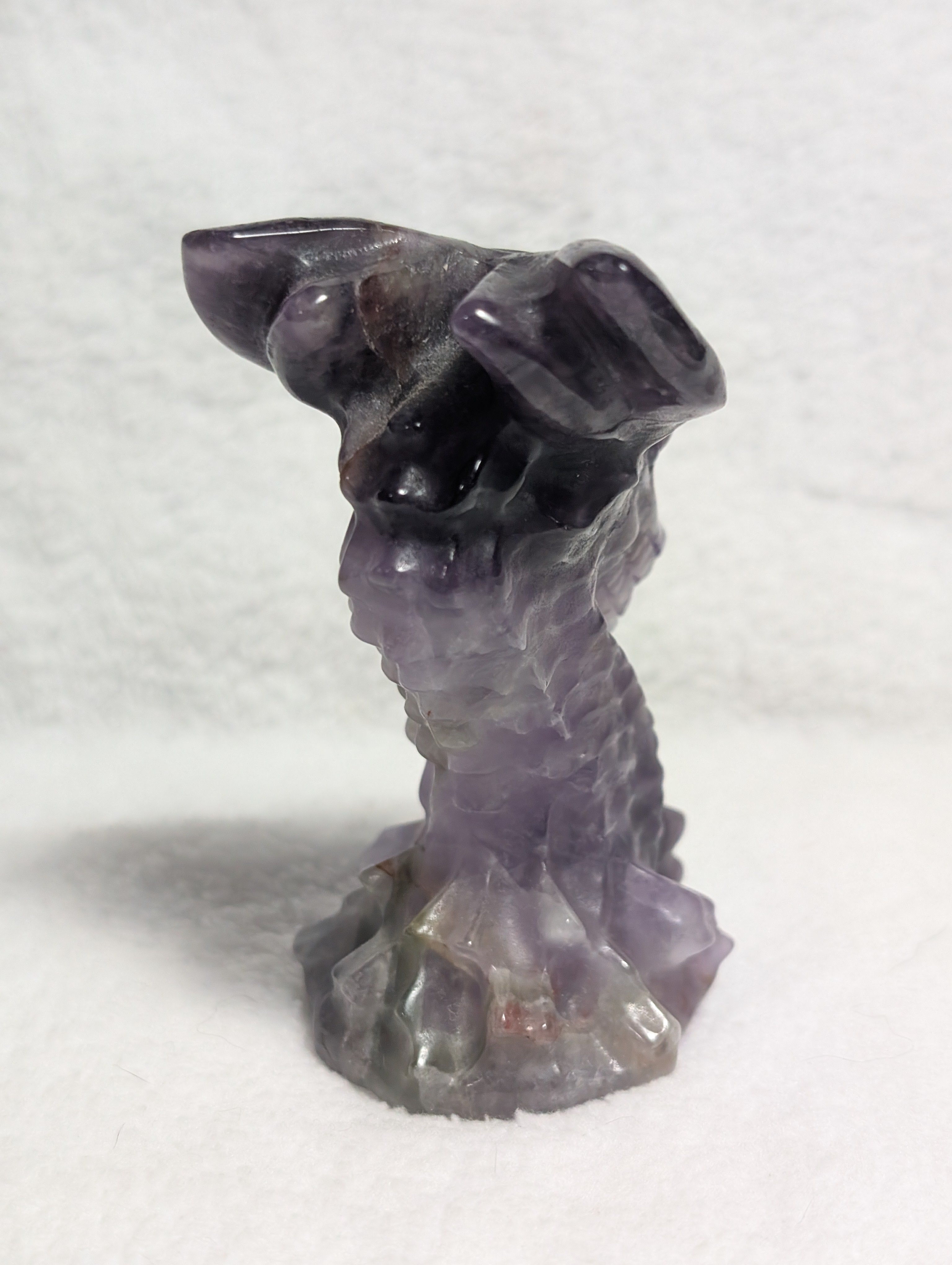 Detailed dragon head carving from Syn's Crystal Co, showcasing intricate craftsmanship and textured surface.
