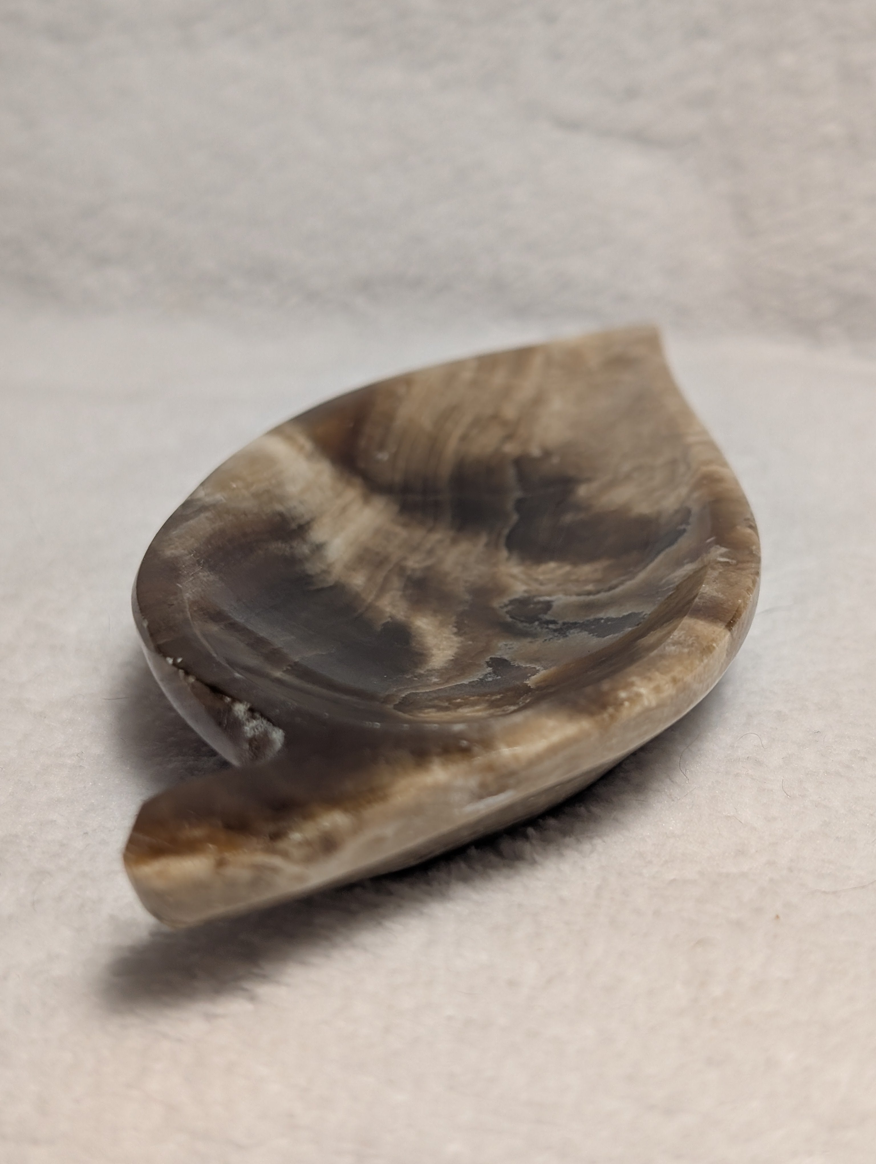 Chocolate Calcite leaf carving by Syn's Crystal Co, showing detailed natural stone with leaf shape and intricate carvings.
