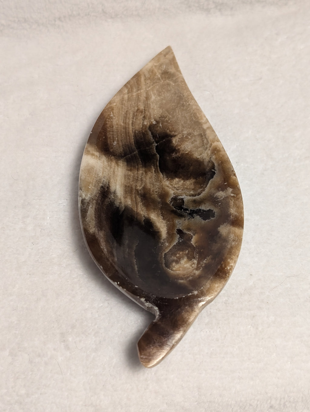 Chocolate Calcite Leaf carving by Syn's Crystal Co, featuring a detailed leaf shape with warm brown and orange tones.