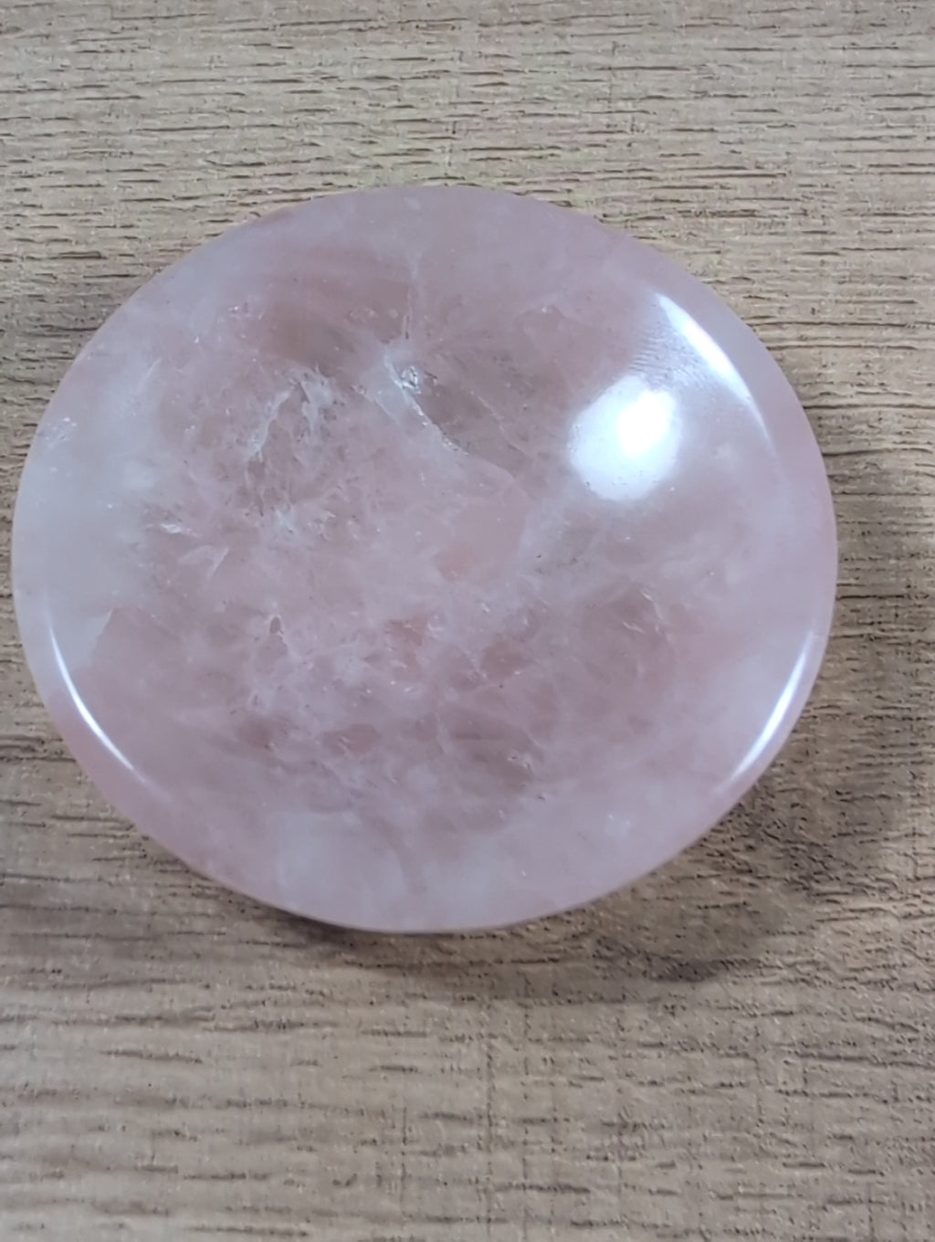 Round rose quartz bowl from Syn's Crystal Co with smooth, polished pink stone surface and a rounded shape.