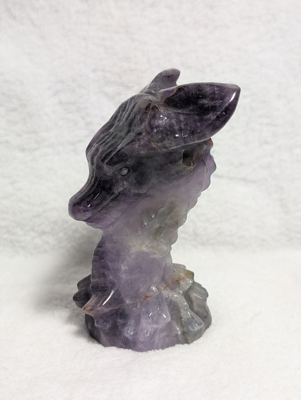 Detailed dragon head carving from Syn's Crystal Co, showcasing intricate design and craftsmanship in a natural stone sculpture.