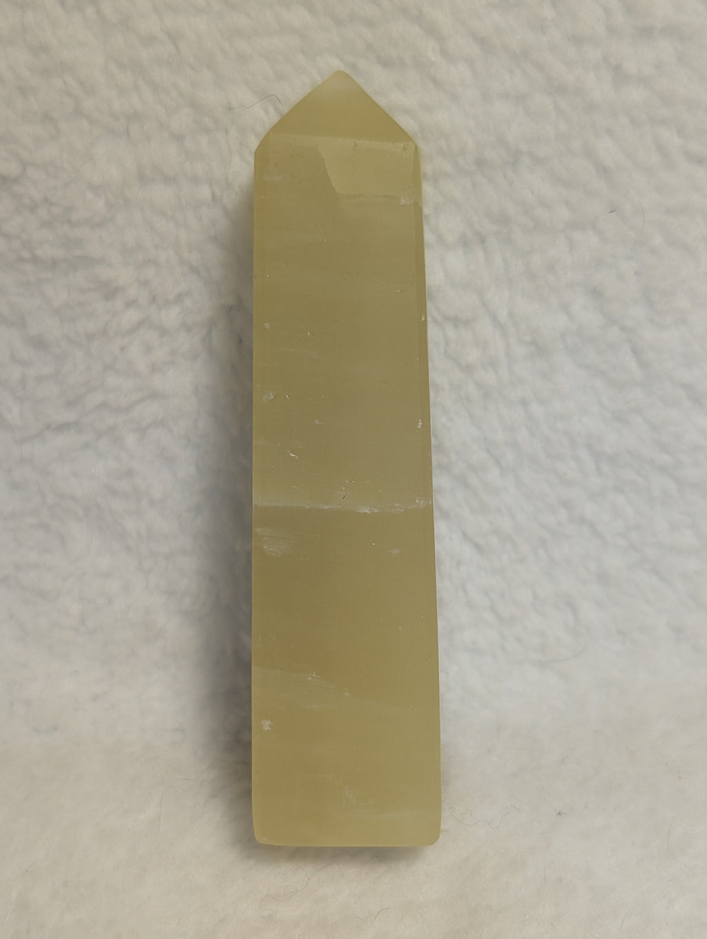 Lemon Calcite Tower from Syn's Crystal Co, showcasing a vibrant yellow mineral crystal with natural striations and smooth polished surface.