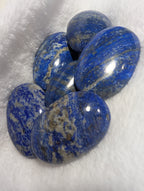 Lapis Lazuli palmstone from Syn's Crystal Co showing deep blue stone with gold and white veining, smooth polished surface.