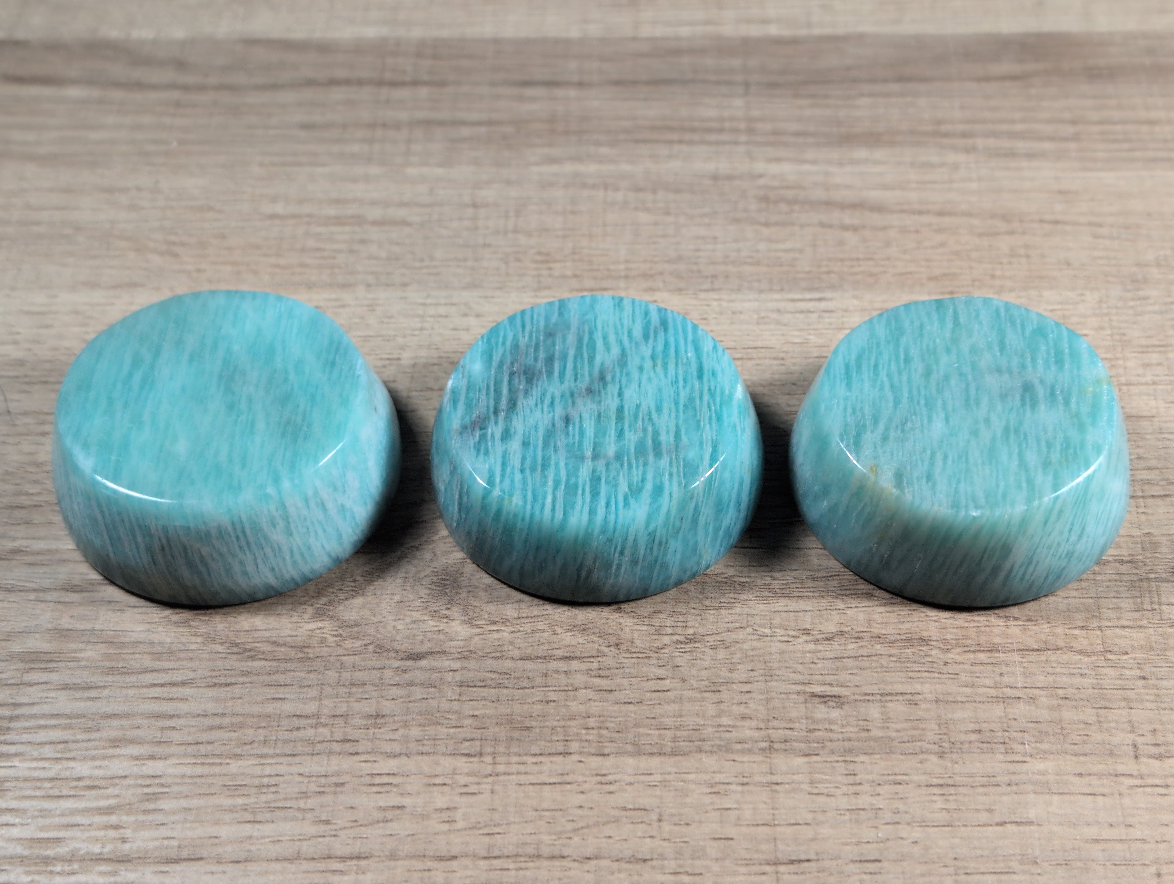 Round Amazonite bowl from Syn's Crystal Co, showcasing smooth, polished blue-green stone with natural veining and a glossy finish.