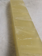 Lemon Calcite Tower from Syn's Crystal Co, showcasing a vibrant yellow crystal point with smooth, polished surface and natural mineral details.