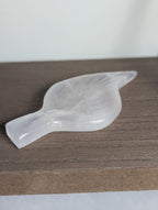 Silky white calcite leaf carving by Syn's Crystal Co, showcasing intricate leaf details and smooth polished surface.