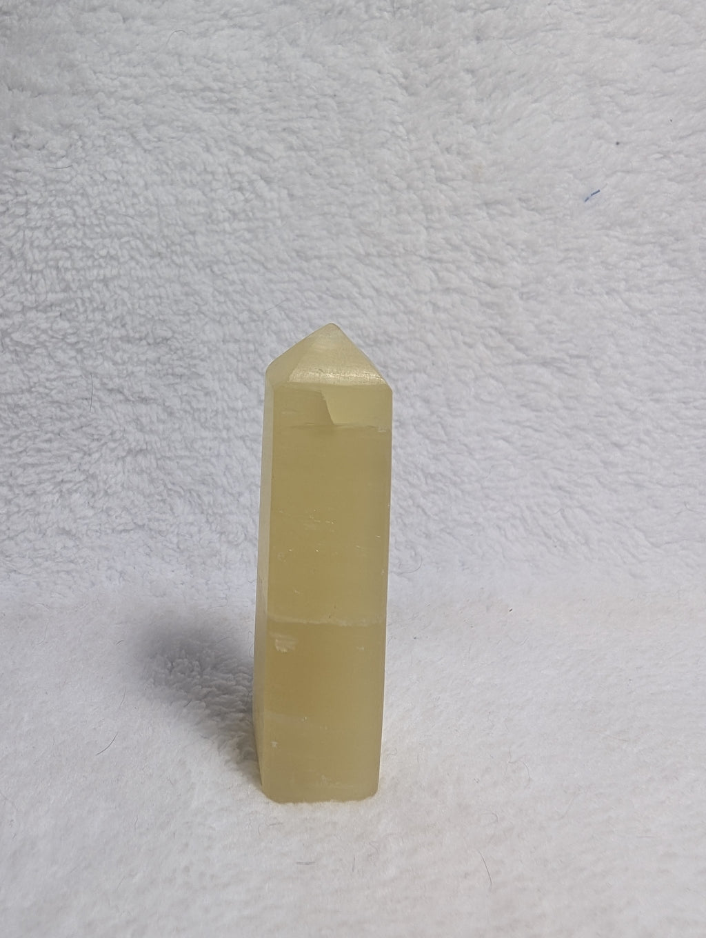 Lemon Calcite Tower from Syn's Crystal Co featuring a vibrant yellow crystal point on a natural mineral base.