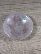 Round rose quartz bowl from Syn's Crystal Co with a smooth polished surface and soft pink hue.