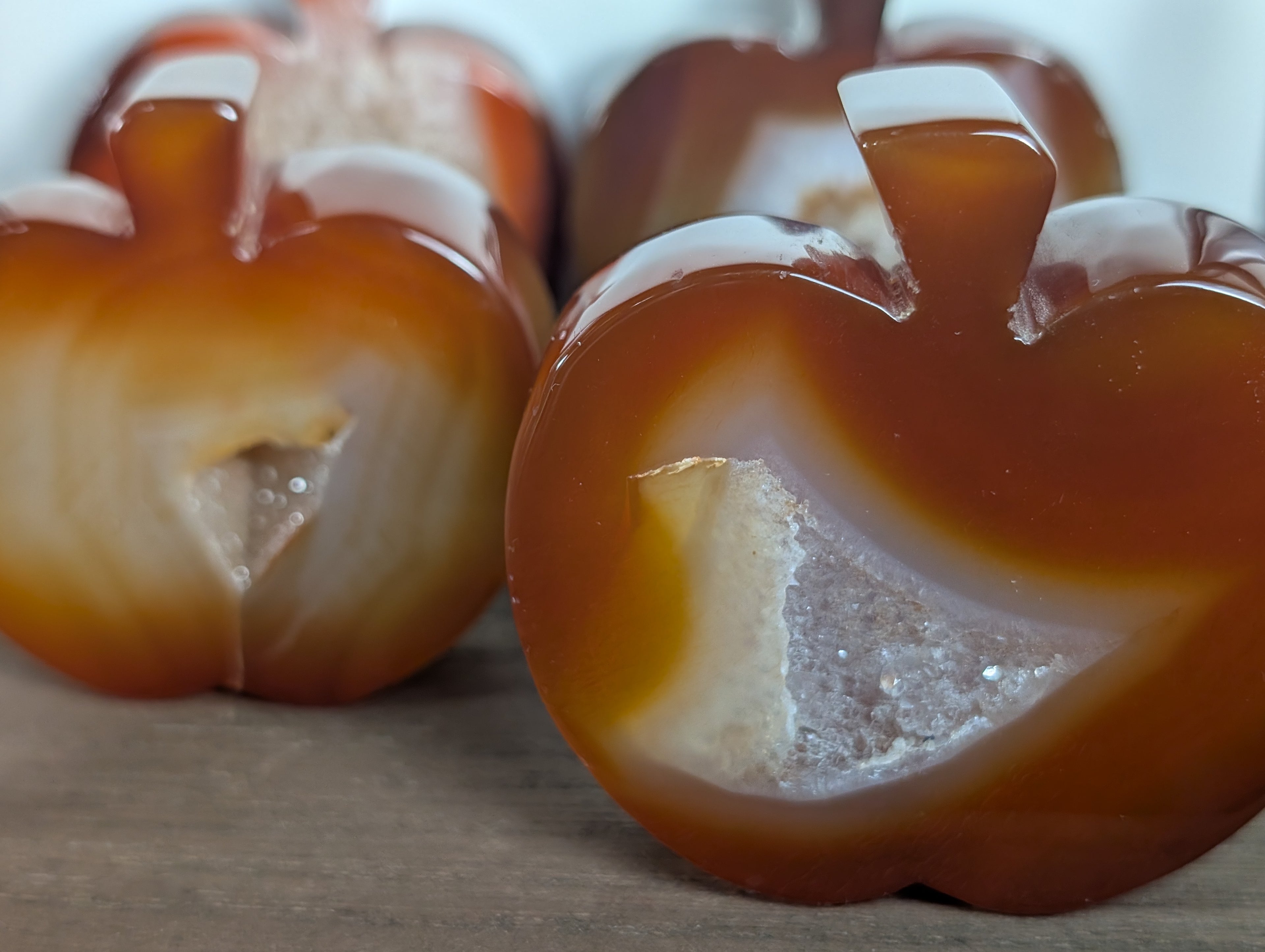 Hand-carved carnelian crystal apple from Syn's Crystal Co, featuring detailed craftsmanship for creativity, motivation, and abundance.