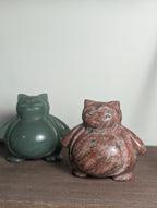 Syn's Crystal Co Snorlax carving, detailed crystal sculpture of the popular Pokémon character, displayed on a wooden base.