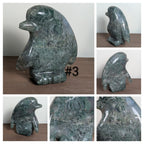 Glass penguin carving by Syn's Crystal Co, showcasing a detailed crystal penguin sculpture on a clear base.
