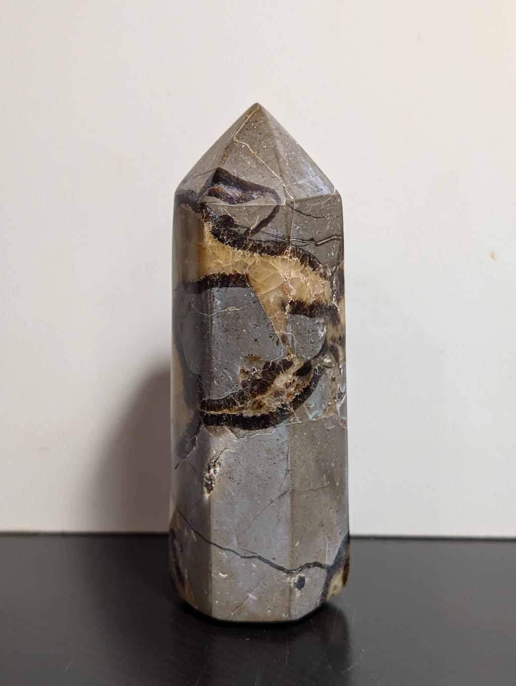 Septarian tower crystal from Syn's Crystal Co featuring earthy brown, yellow, and gray mineral patterns with a polished finish.