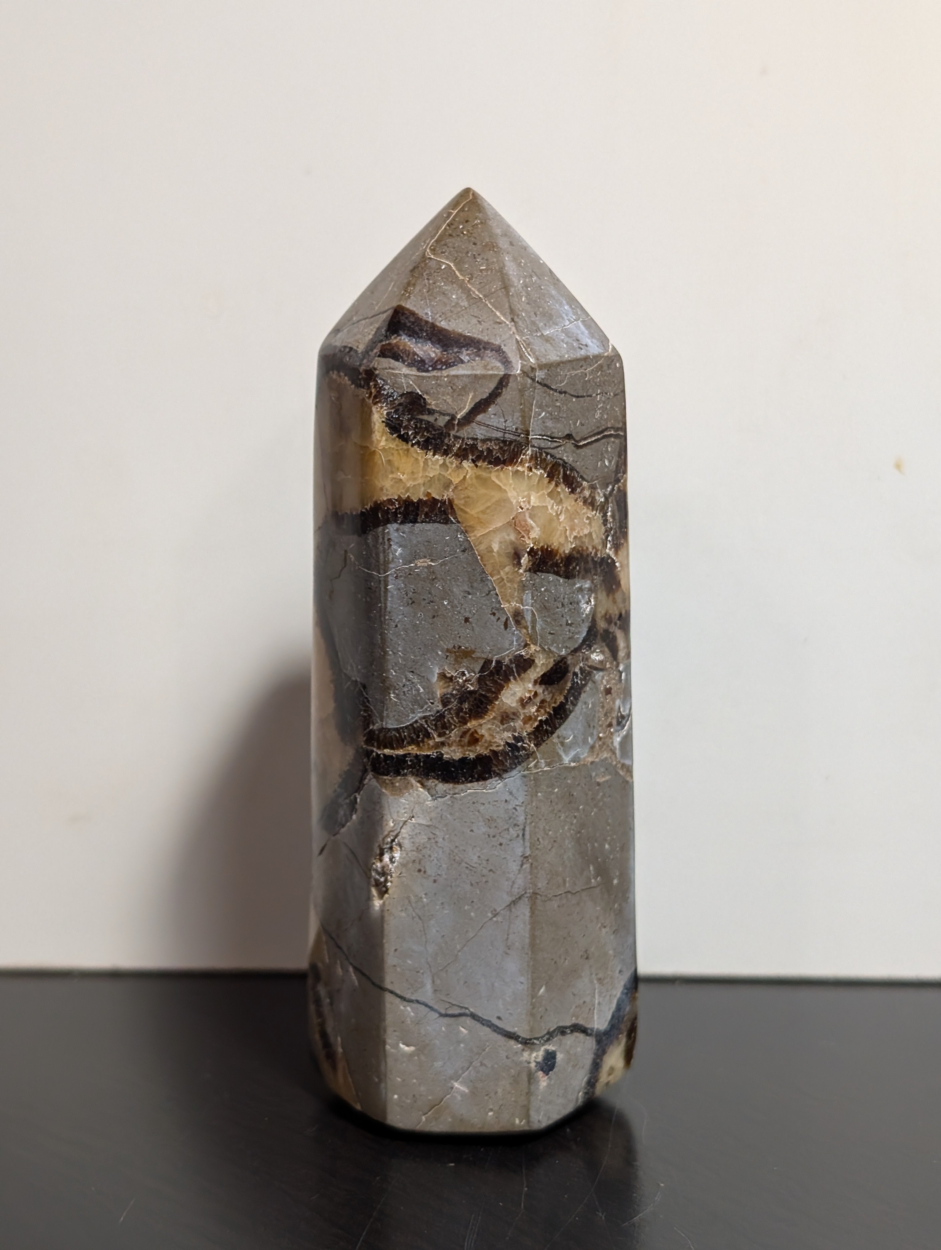 Septarian tower crystal from Syn's Crystal Co featuring earthy brown, yellow, and gray mineral patterns with a polished finish.