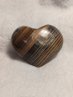 Bumblebee Calcite Heart from Syn's Crystal Co showing a polished yellow and black calcite heart with natural patterns and smooth surface.