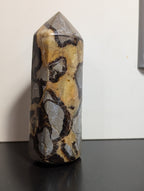 Septarian tower crystal from Syn's Crystal Co, featuring earthy brown and yellow mineral patterns with a polished, natural finish.