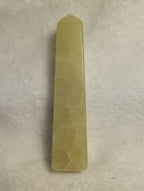 Lemon calcite crystal tower from Syn's Crystal Co, showing a vibrant yellow mineral point with natural gemstone texture.