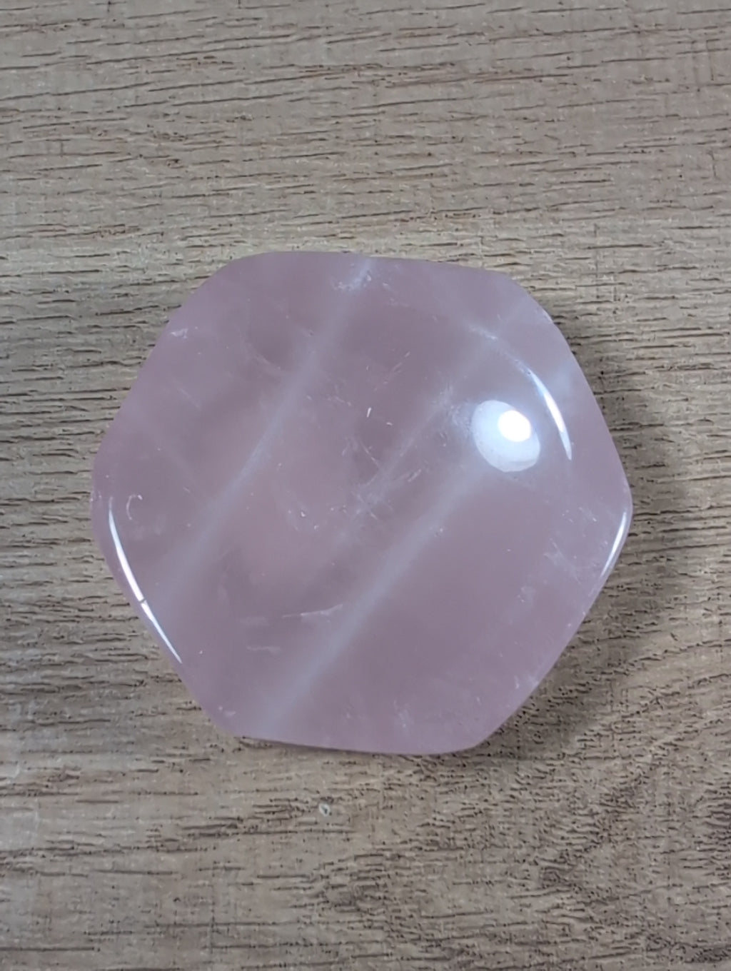 Hexagon-shaped rose quartz bowl from Syn's Crystal Co, showcasing smooth pink crystal with a polished surface and geometric design.