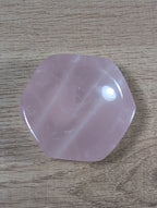 Hexagon-shaped rose quartz bowl from Syn's Crystal Co, showcasing smooth pink crystal with a polished surface and geometric design.