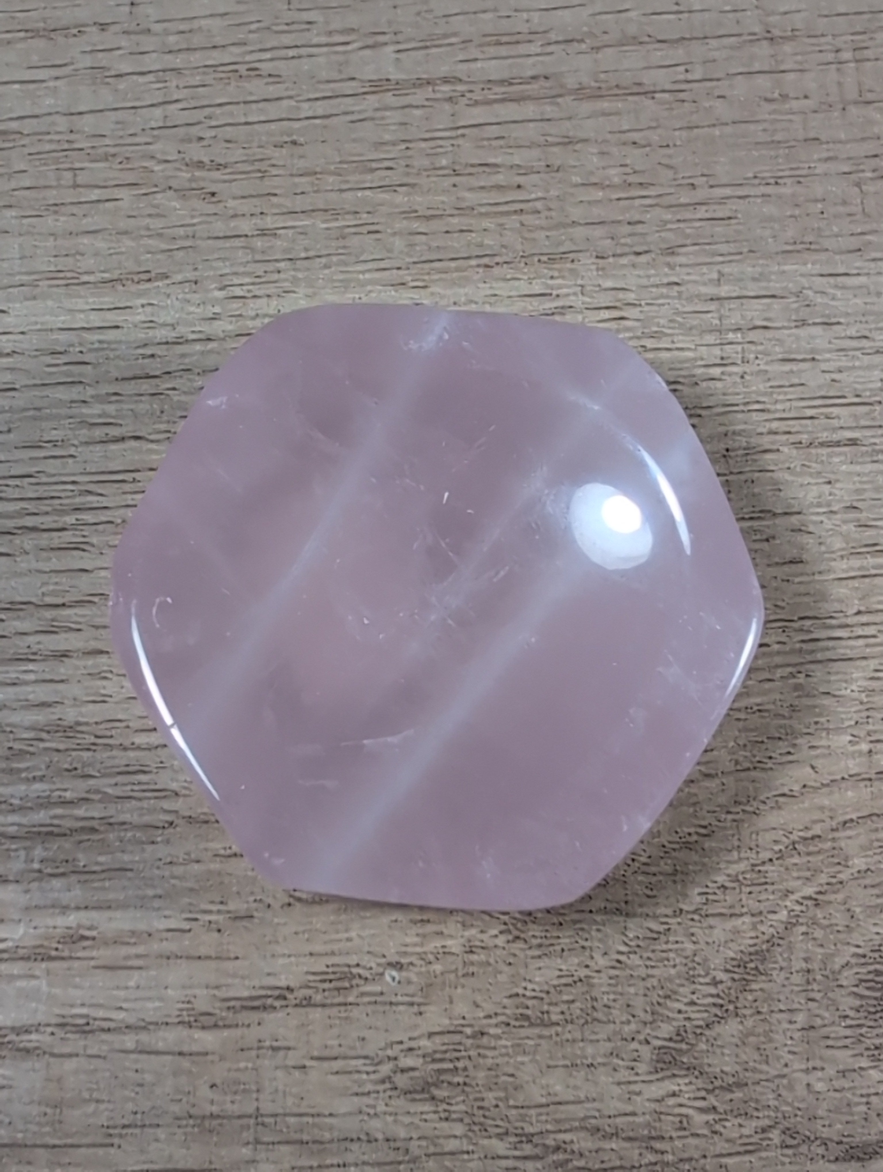 Hexagon-shaped rose quartz bowl from Syn's Crystal Co, showcasing smooth pink crystal with a polished surface and geometric design.