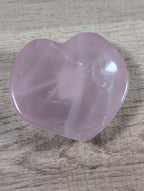 Heart-shaped rose quartz bowl by Syn's Crystal Co, featuring a smooth, polished pink gemstone with a carved heart design.
