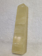 Lemon Calcite Tower from Syn's Crystal Co, showcasing a vibrant yellow crystal point with natural mineral textures.