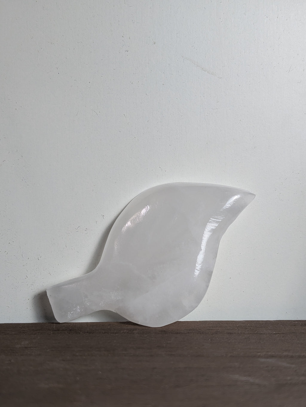 Silky white calcite leaf carving by Syn's Crystal Co, detailed natural stone sculpture with intricate leaf design.
