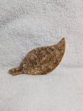 Chocolate Calcite Leaf crystal from Syn's Crystal Co, showing a polished brown and green gemstone shaped like a leaf.