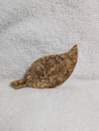 Chocolate Calcite Leaf crystal from Syn's Crystal Co, showing a polished brown and green gemstone shaped like a leaf.