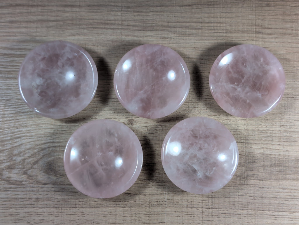 Round rose quartz bowl from Syn's Crystal Co with smooth, pink crystal surface and polished finish.