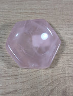 Hexagon-shaped rose quartz bowl from Syn's Crystal Co, showing smooth pink crystal with polished facets on a white background.