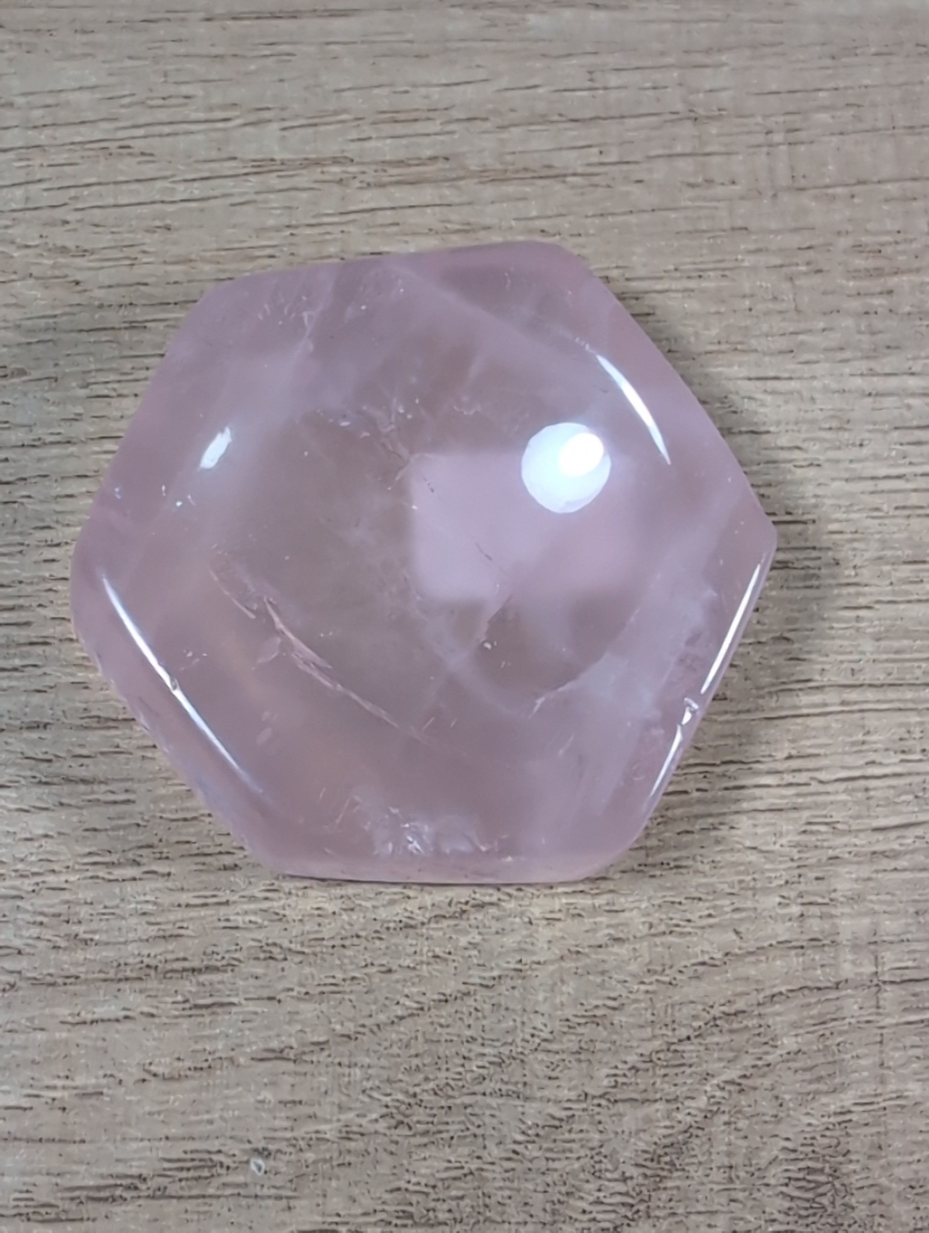 Hexagon-shaped rose quartz bowl from Syn's Crystal Co, showing smooth pink crystal with polished facets on a white background.