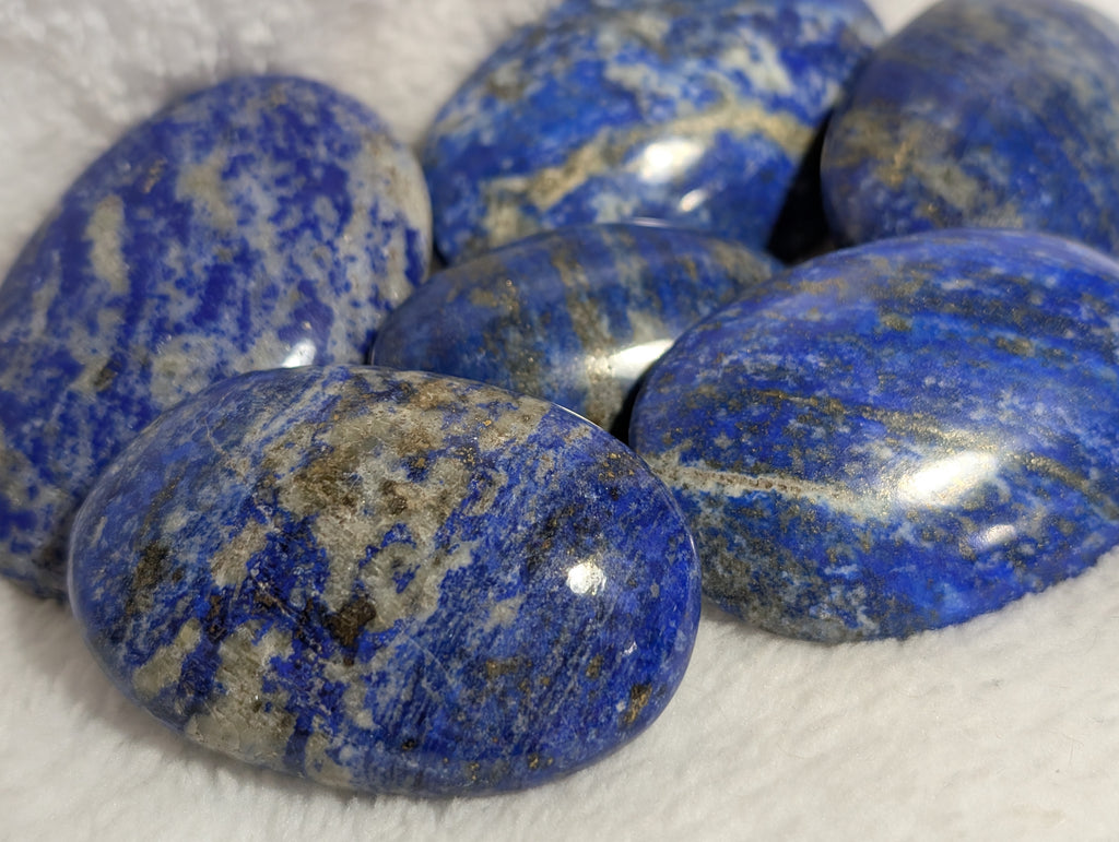 Lapis Lazuli palmstone by Syn's Crystal Co, smooth deep blue gemstone with gold pyrite flecks, for meditation and healing.