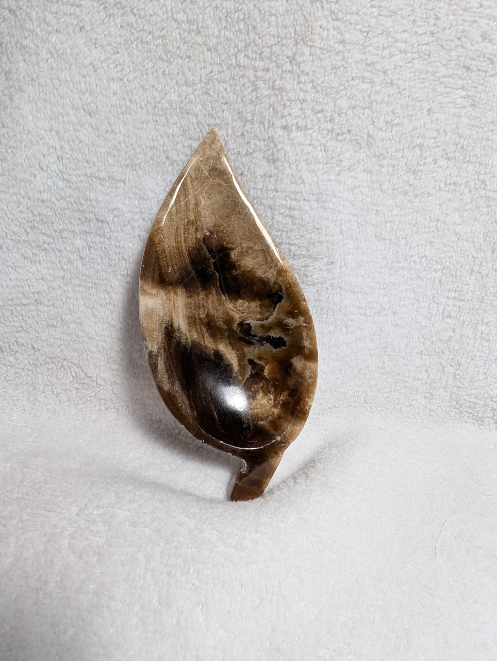 Chocolate Calcite Leaf carving by Syn's Crystal Co featuring a detailed chocolate-colored calcite leaf sculpture.