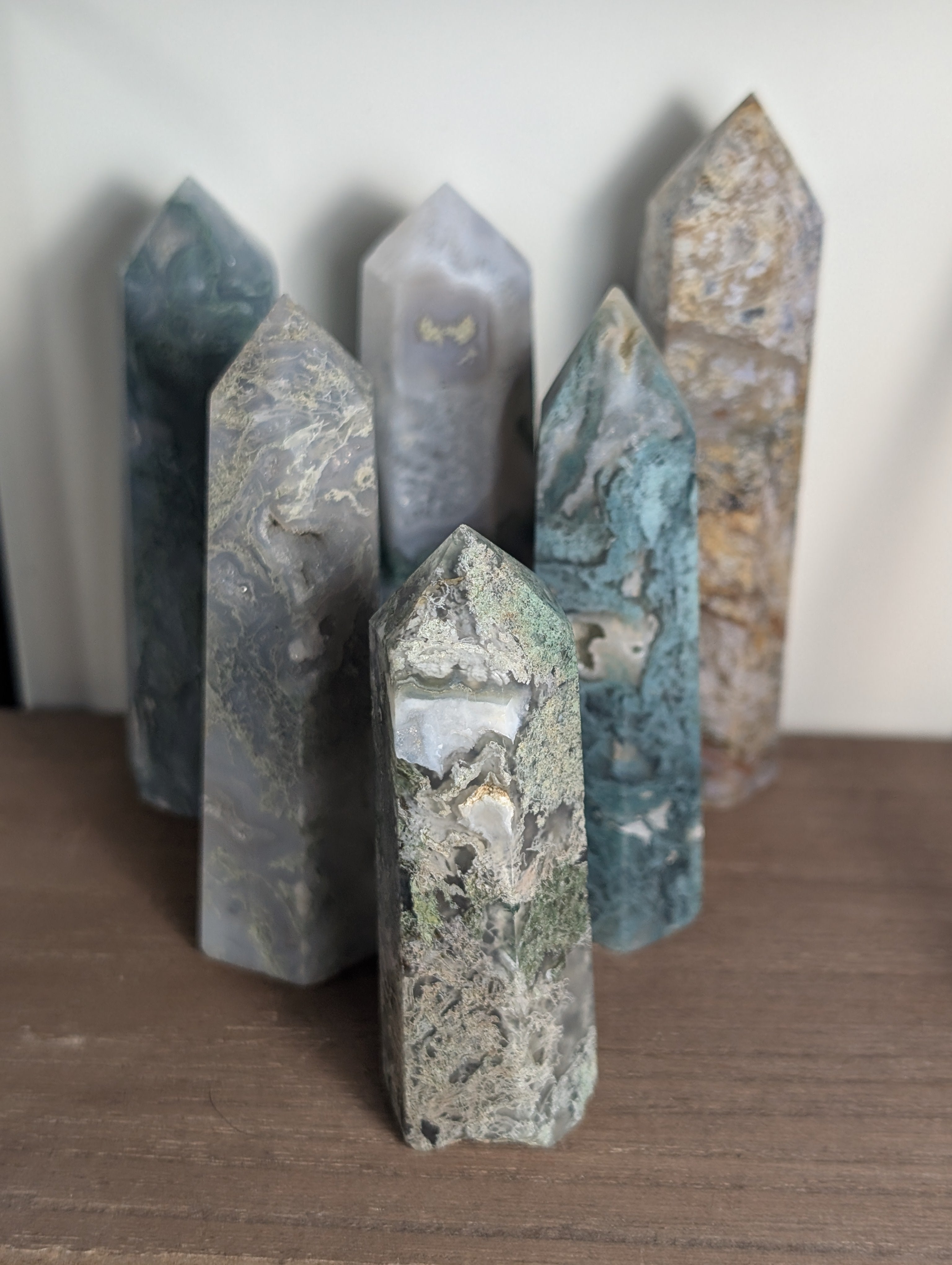 Natural moss agate crystal tower from Syn's Crystal Co, showcasing green and brown moss patterns, perfect for grounding and abundance.