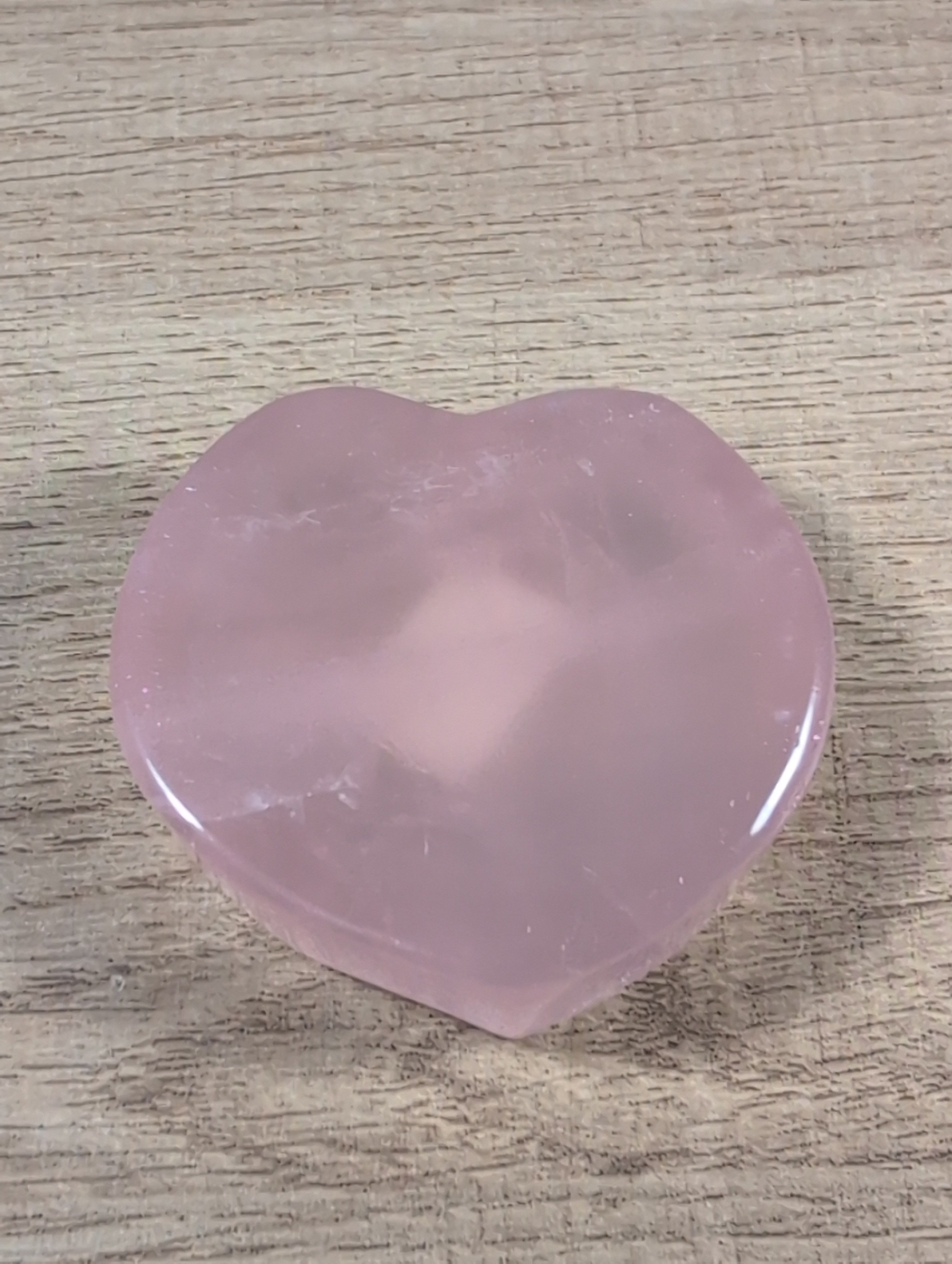 Heart-shaped rose quartz bowl from Syn's Crystal Co, featuring a smooth pink gemstone with a polished finish.